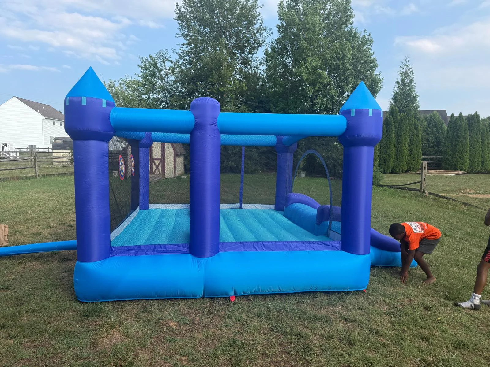 Blue bouncy house set up outdoors.