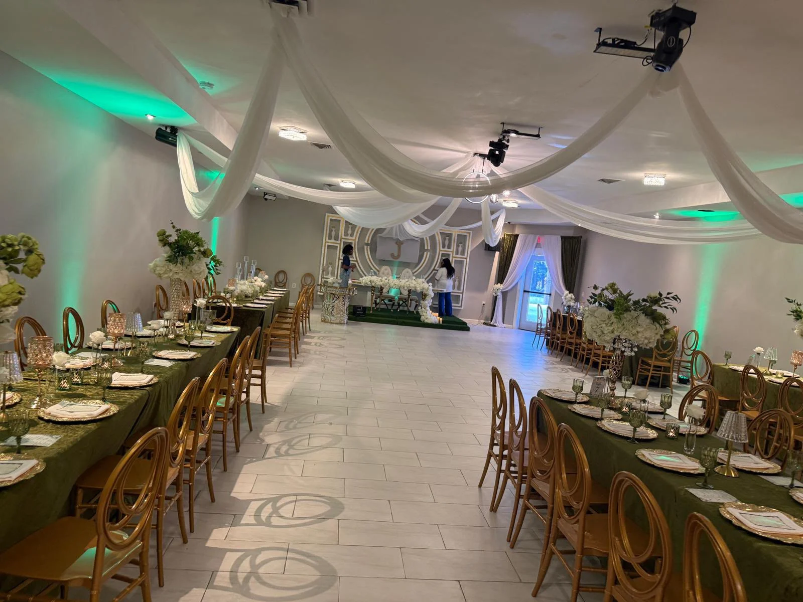 A celebration setup at Continental with gold chairs and a decorated focal area